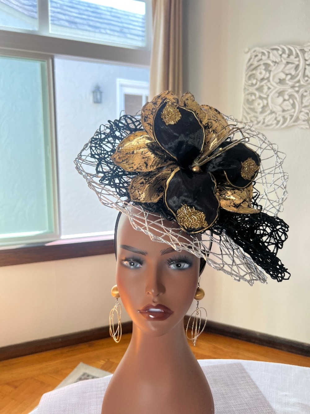 Oversized black and gold glittered flower on a silver and black woven base